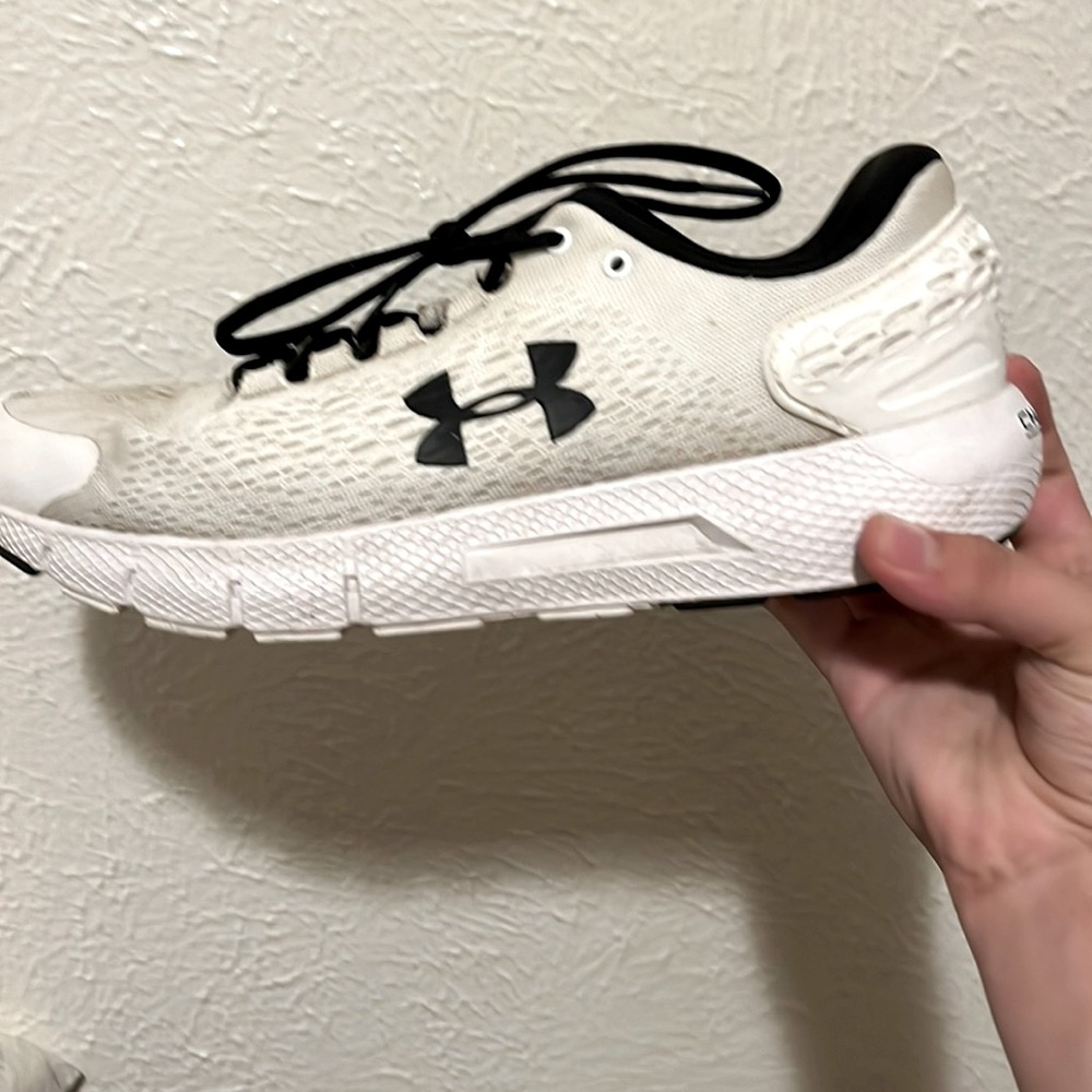 One primary white and black under armor shoe size 13 and one primary black 13